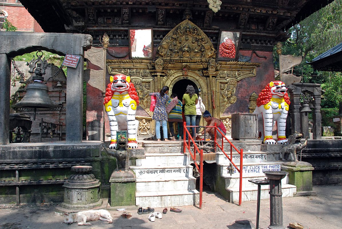 10 Kathmandu Valley Sankhu Vajrayogini Temple Entrance With Two White Snow Lions, Bells and Torana Door 